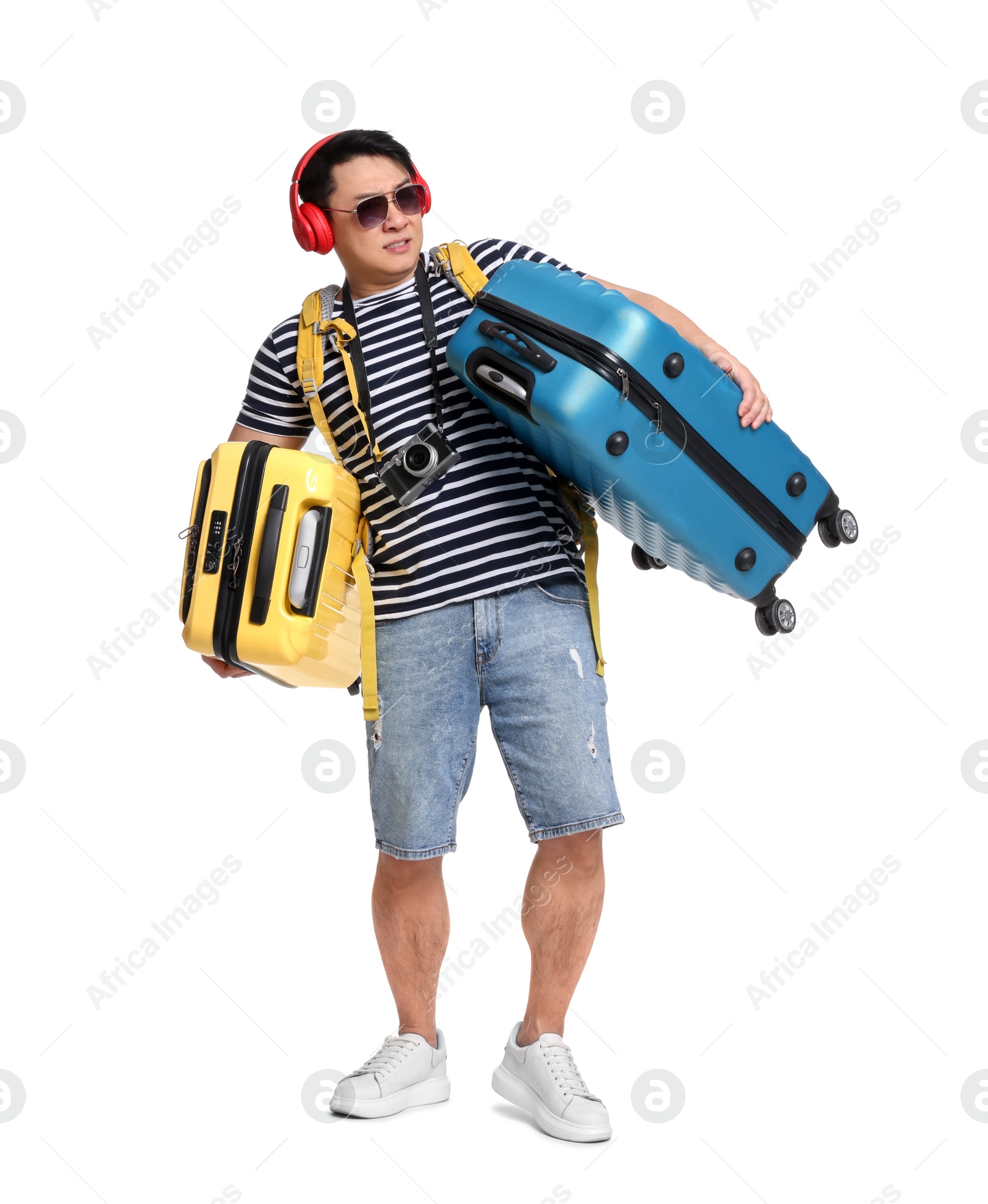 Photo of Traveller carrying heavy suitcases on white background