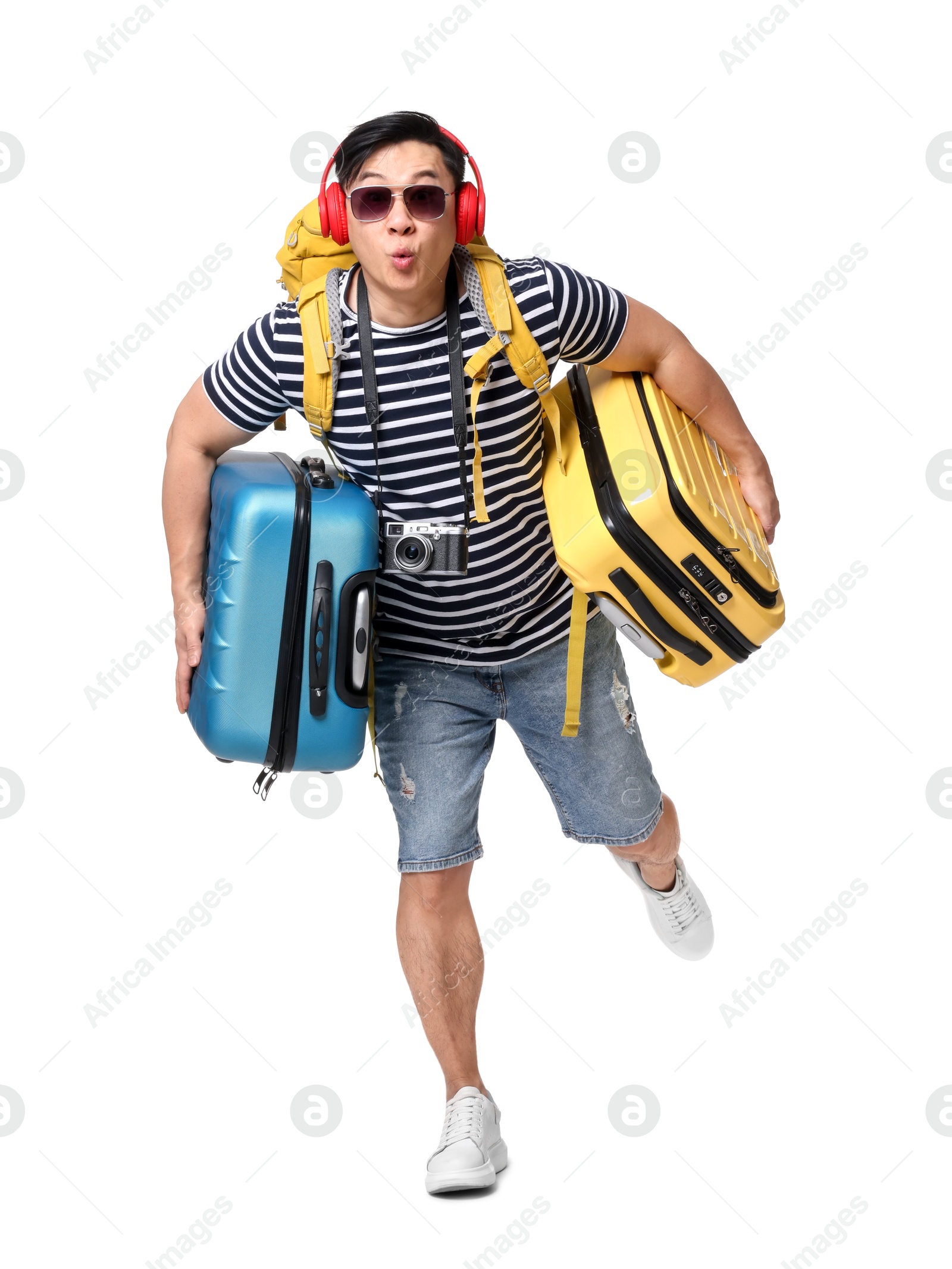 Photo of Traveller with suitcases running on white background