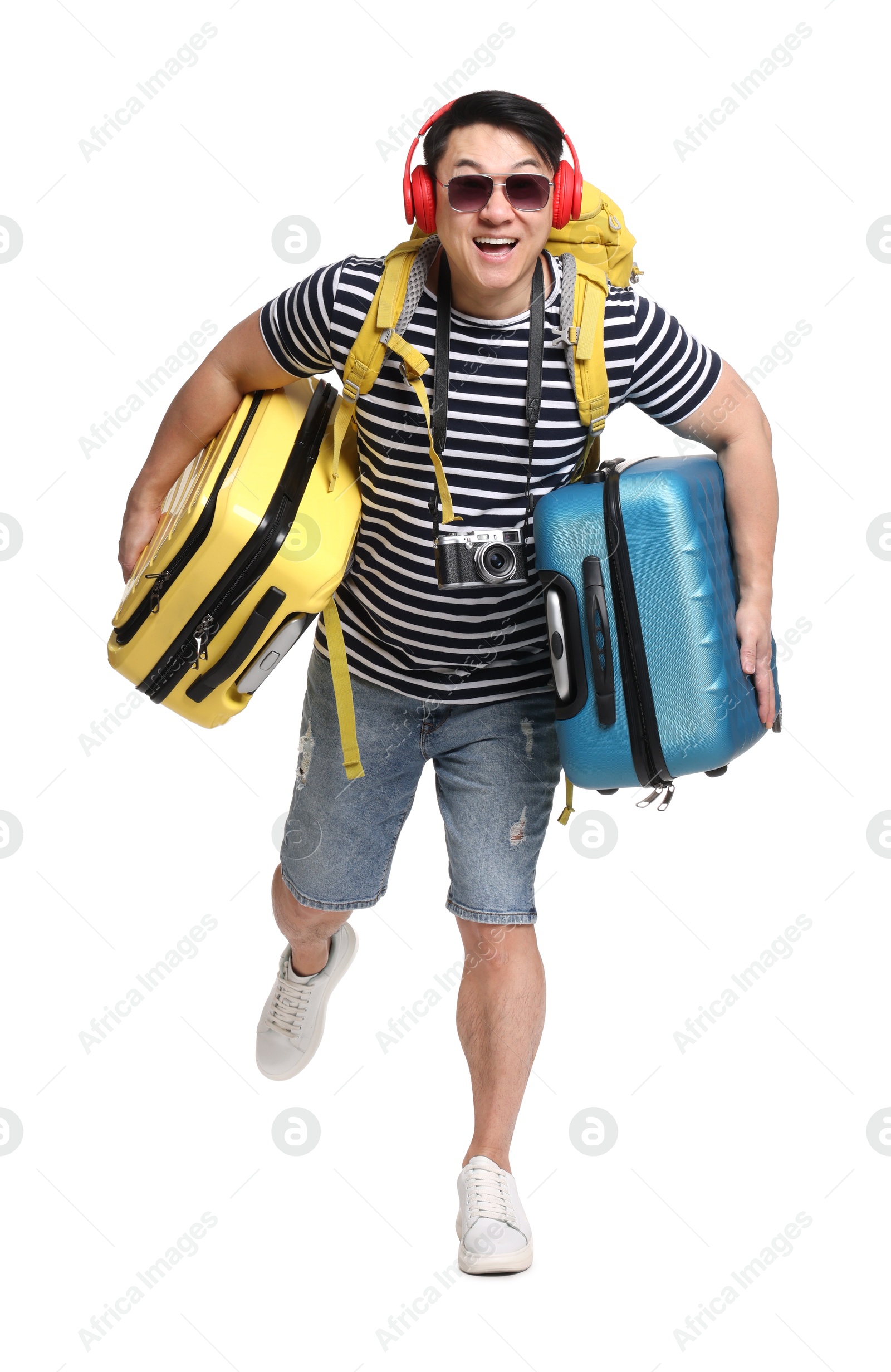 Photo of Traveller with suitcases running on white background