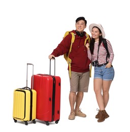 Photo of Happy travellers with suitcases on white background