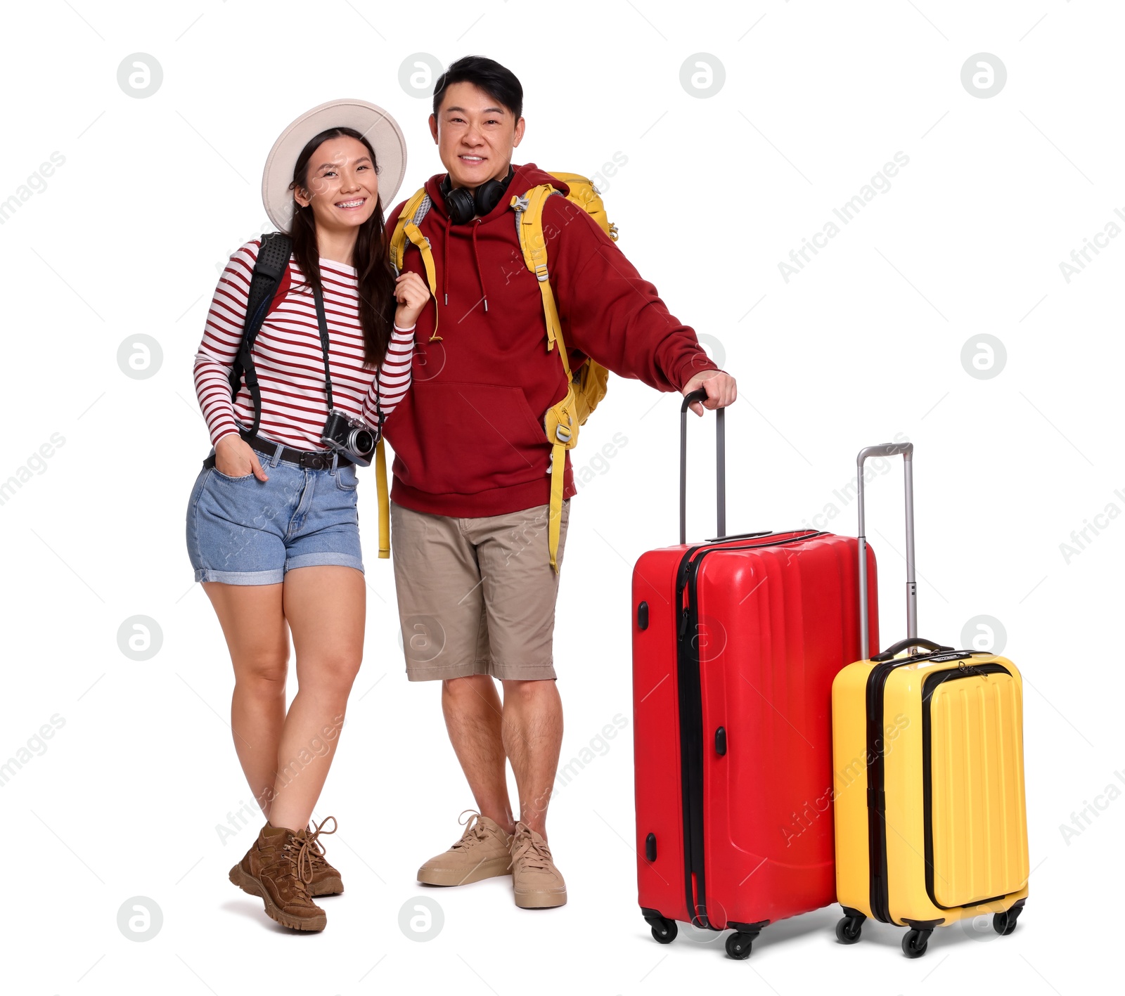 Photo of Happy travellers with suitcases on white background