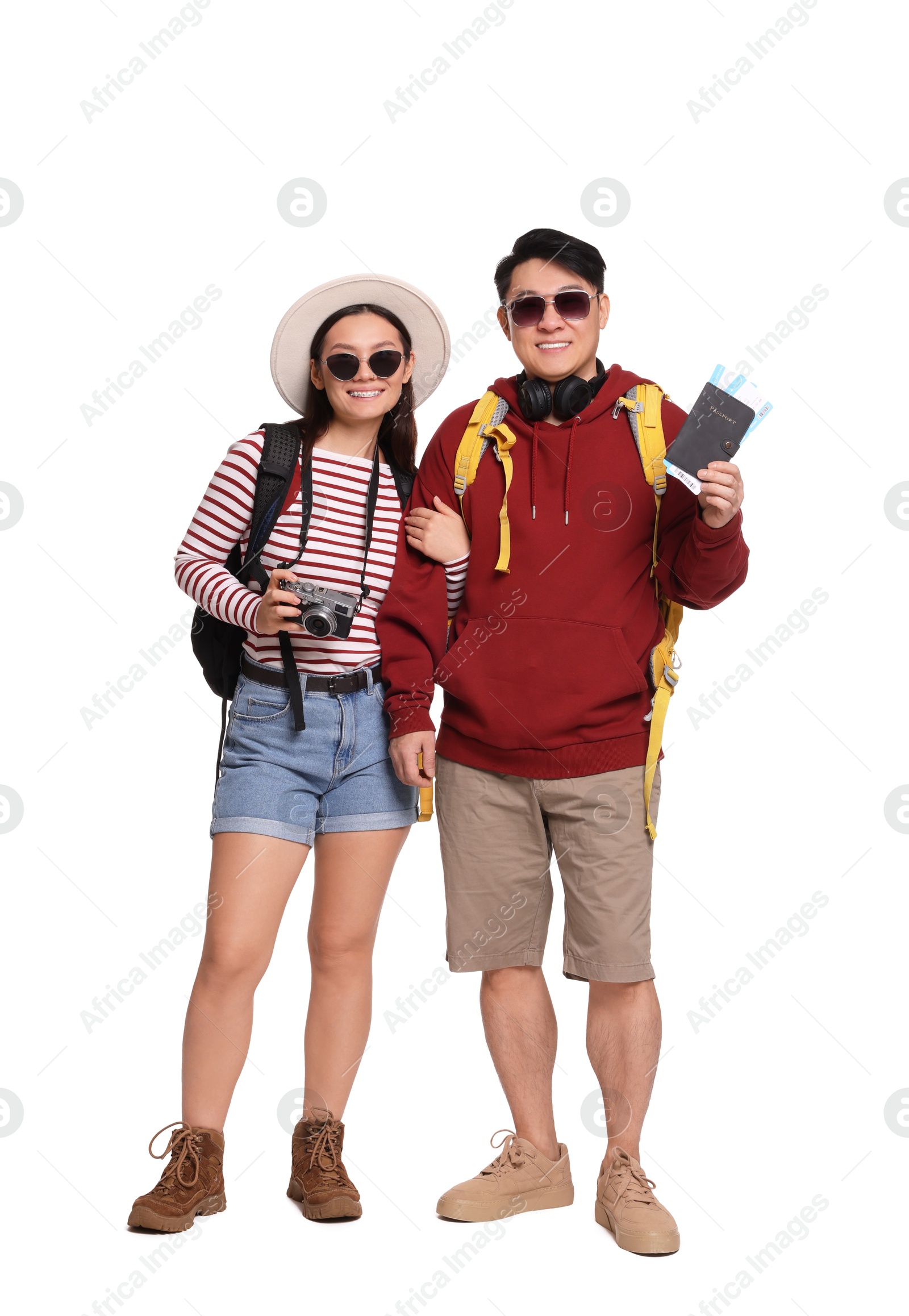 Photo of Happy travellers with passports and camera on white background