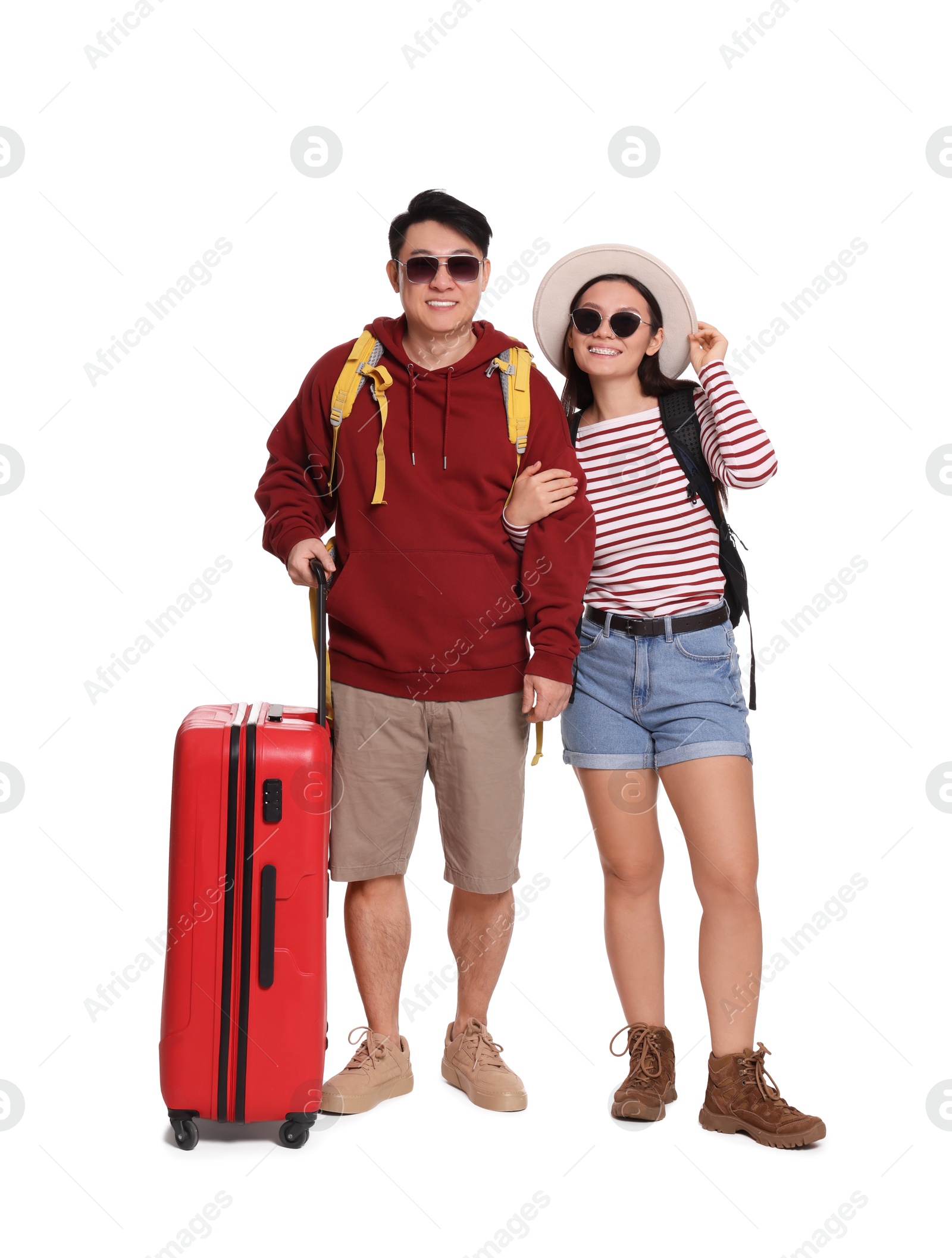 Photo of Happy travellers with suitcase on white background