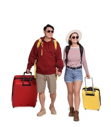 Photo of Happy travellers with suitcases on white background