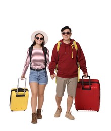 Photo of Happy travellers with suitcases on white background