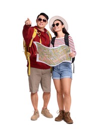 Photo of Happy travellers with map pointing at something on white background