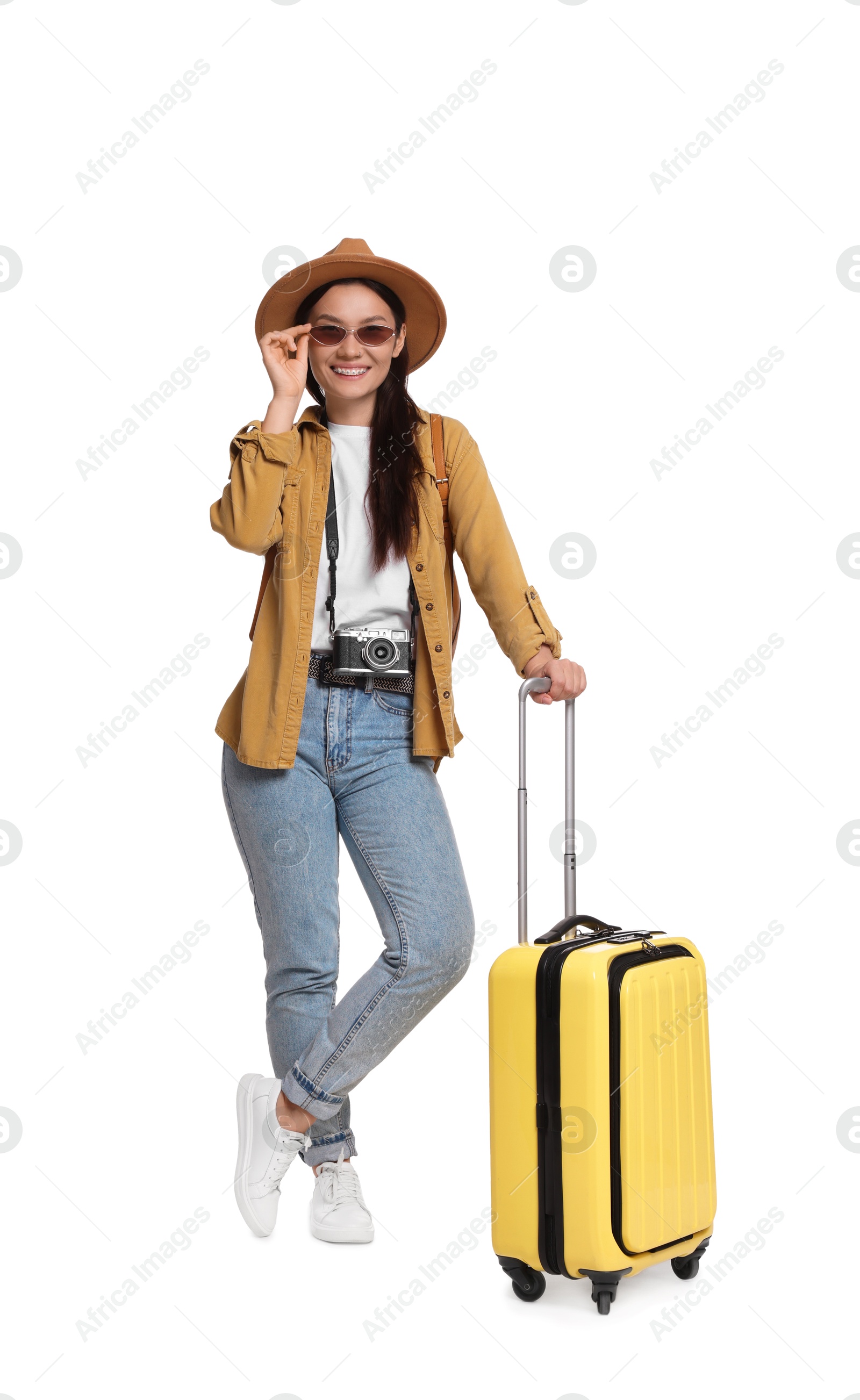 Photo of Happy traveller with suitcase on white background