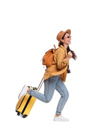 Photo of Traveller with suitcase running on white background