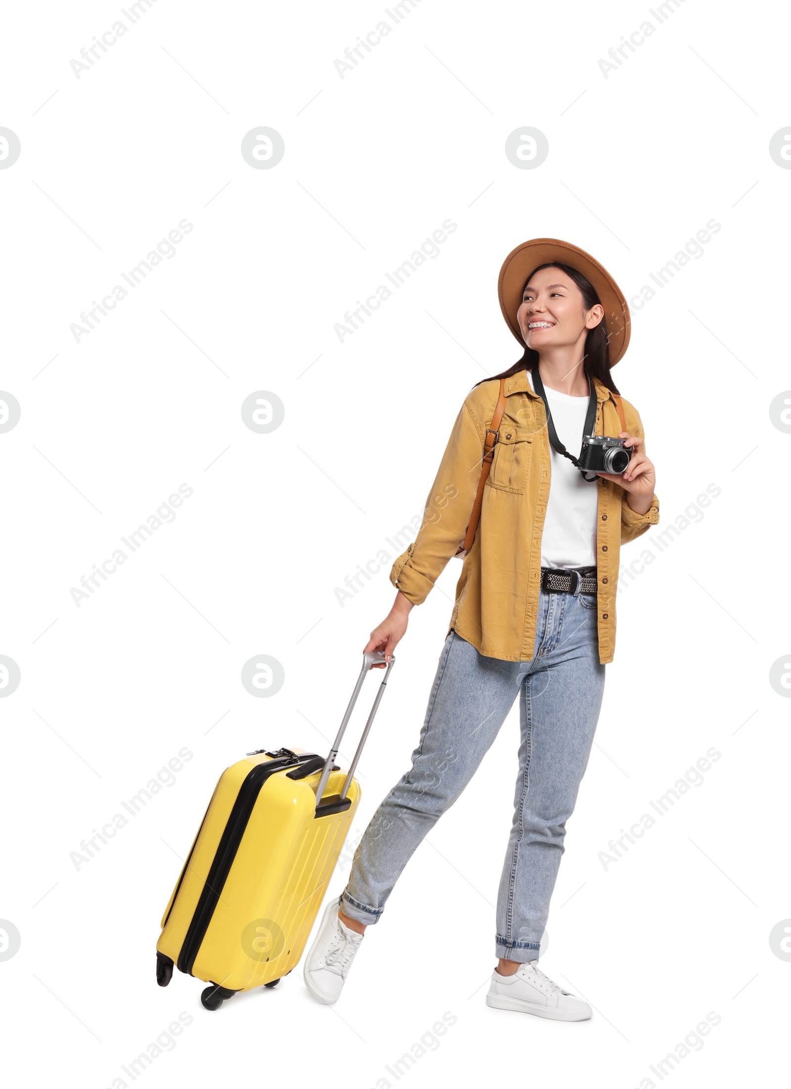 Photo of Happy traveller with suitcase on white background