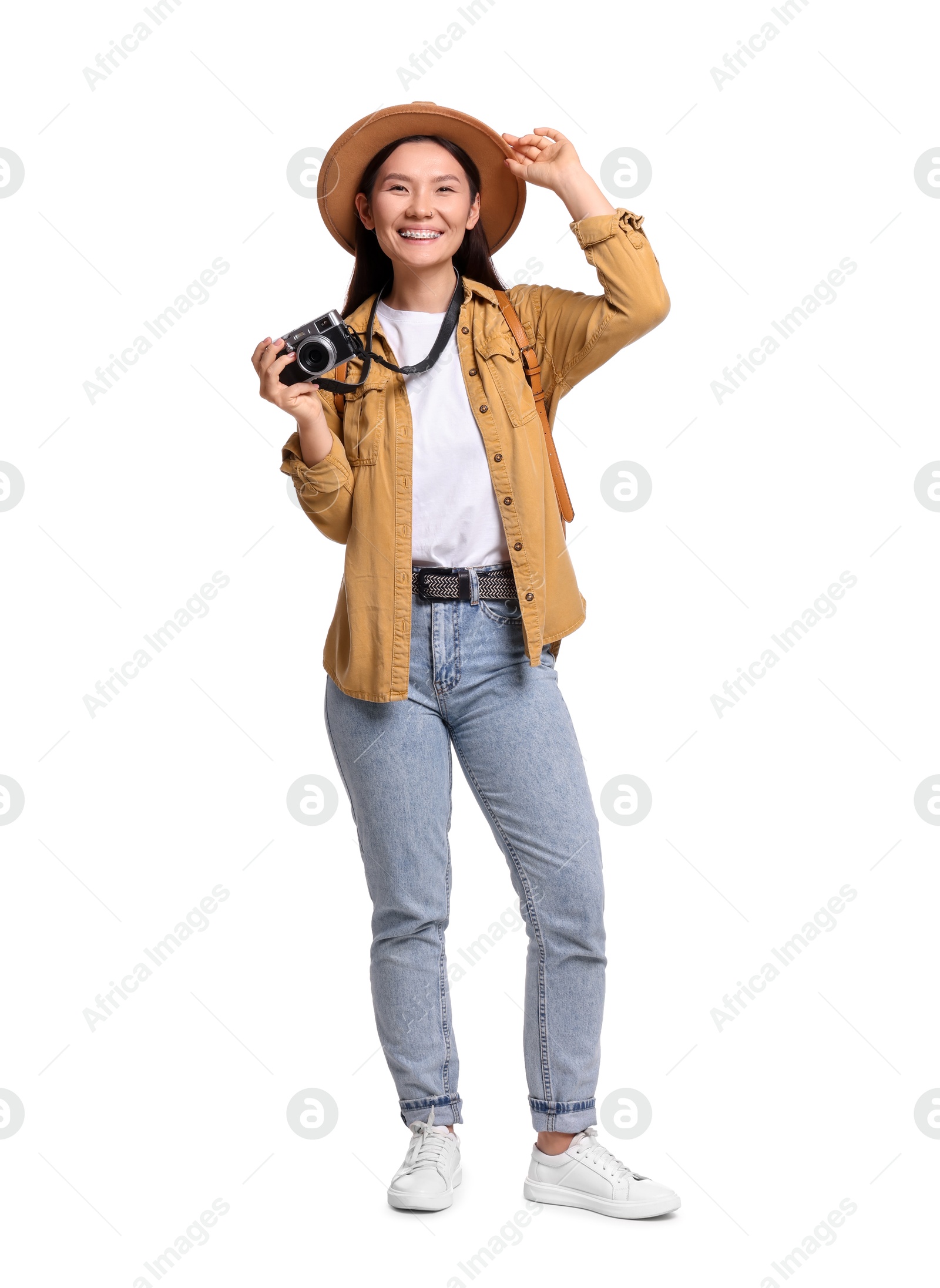 Photo of Happy traveller with camera on white background