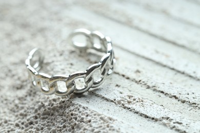 Beautiful silver ring on stone surface, closeup. Space for text