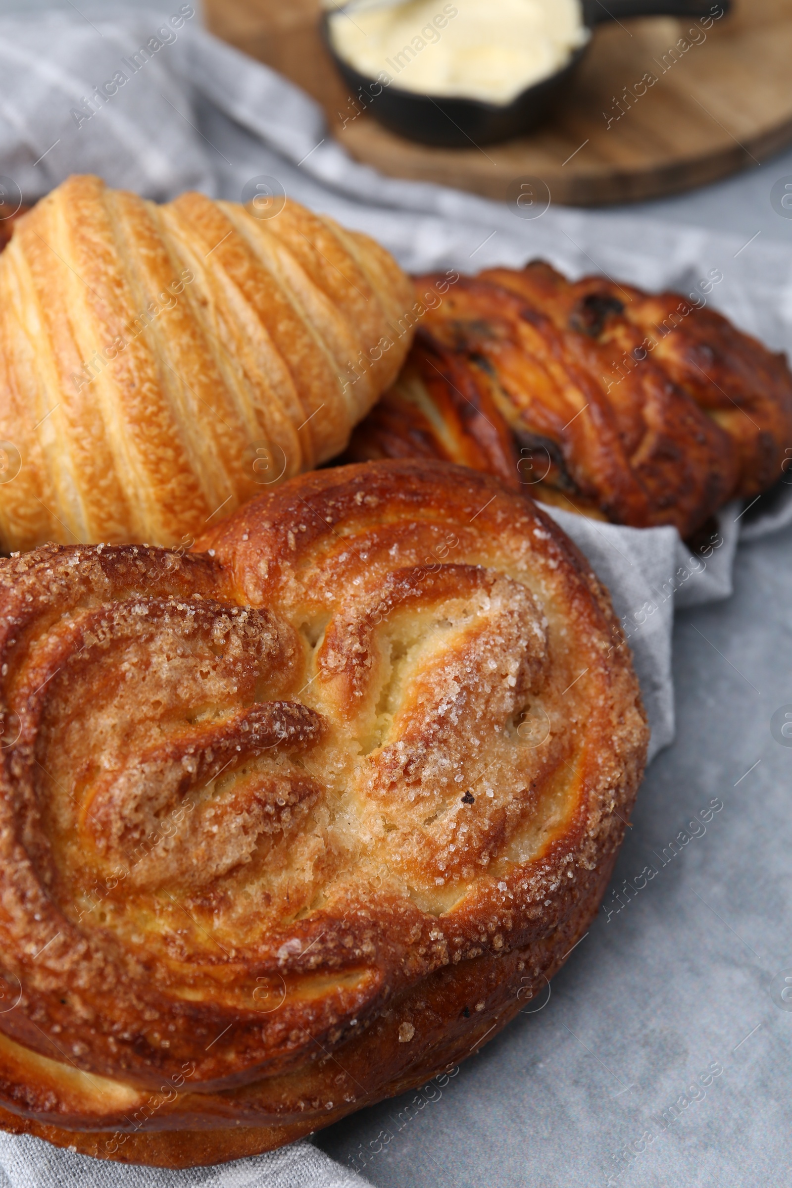 Photo of Different delicious pastries on grey table, closeup