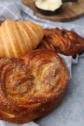 Photo of Different delicious pastries on grey table, closeup