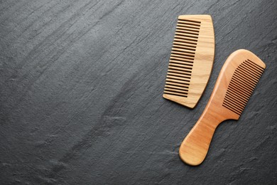 Different wooden hair combs on grey background, top view. Space for text