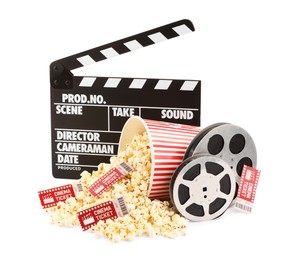 Photo of Tasty popcorn, film reels, clapper and movie tickets isolated on white