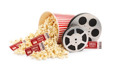 Photo of Tasty popcorn, film reels and movie tickets isolated on white