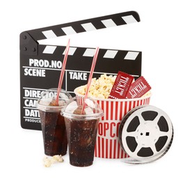 Photo of Tasty popcorn, film reel, clapper, soda drinks and movie tickets isolated on white