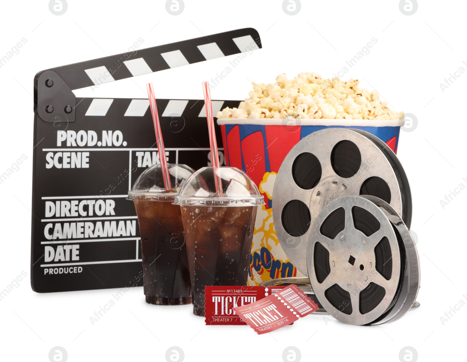 Photo of Tasty popcorn, film reels, clapper, soda drinks and movie tickets isolated on white