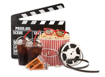 Photo of Tasty popcorn, film reel, glasses, clapper, soda drinks and movie tickets isolated on white