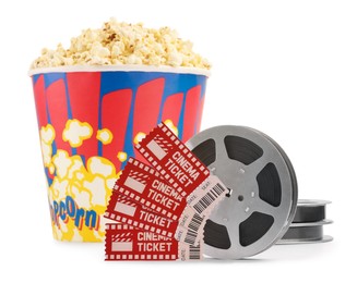 Photo of Tasty popcorn, film reels and movie tickets isolated on white