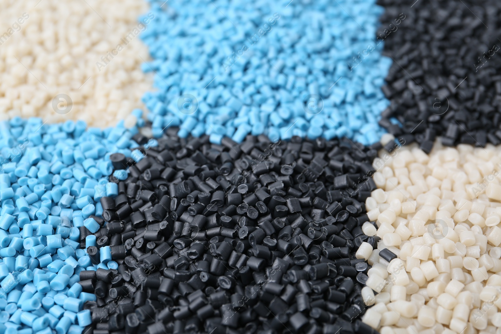 Photo of Pile of colorful plastic granules as background, closeup