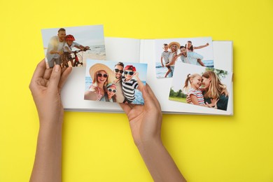 Photo of Woman with open photo album and different photos on yellow background, top view