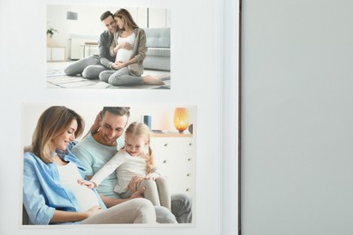 Photo of Open photo album with photos on grey background, top view