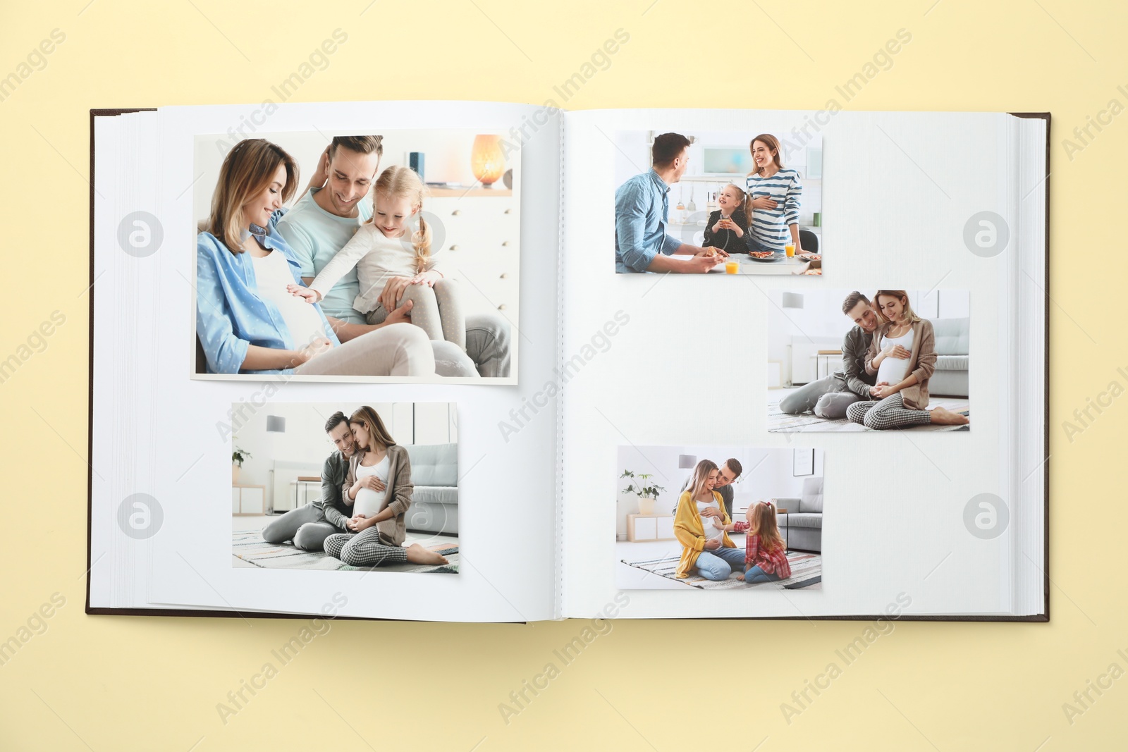 Photo of Open photo album with different photos on beige background, top view