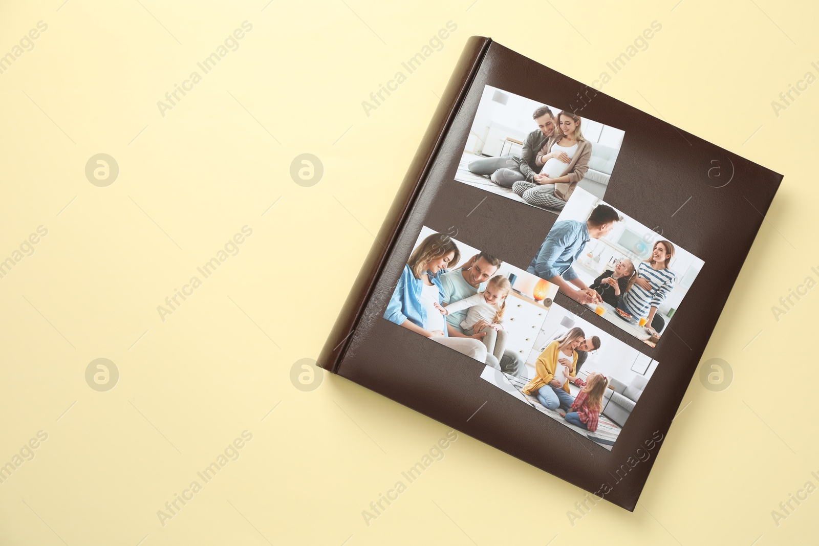 Photo of Photo album with different photos on beige background, top view. Space for text