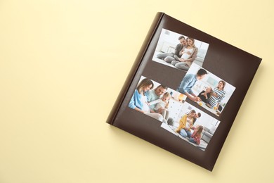 Photo of Photo album with different photos on beige background, top view. Space for text