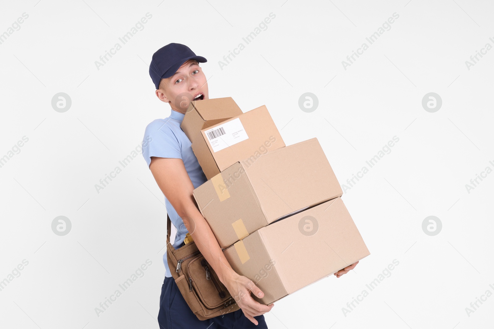 Photo of Postman with bag and parcels on white background