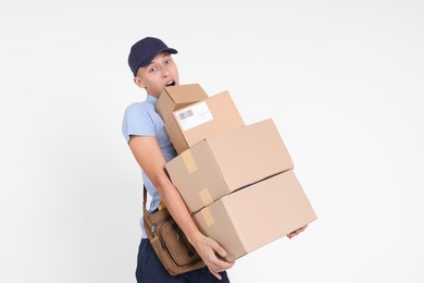 Photo of Postman with bag and parcels on white background