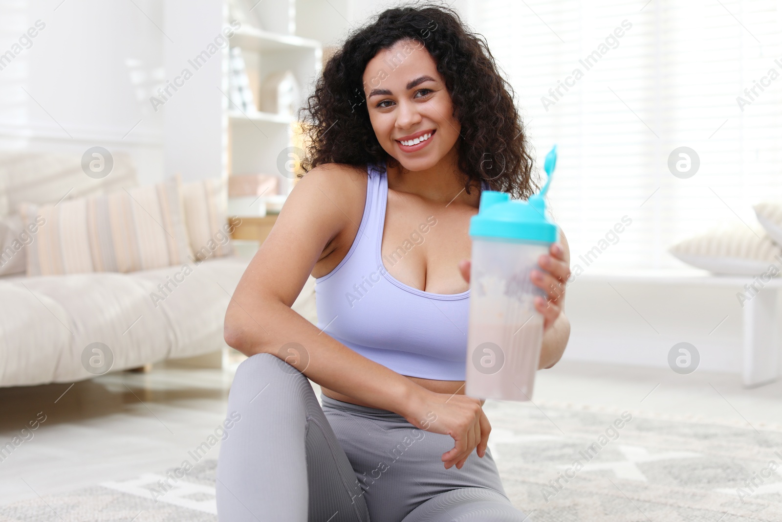 Photo of Beautiful woman with protein shake at home