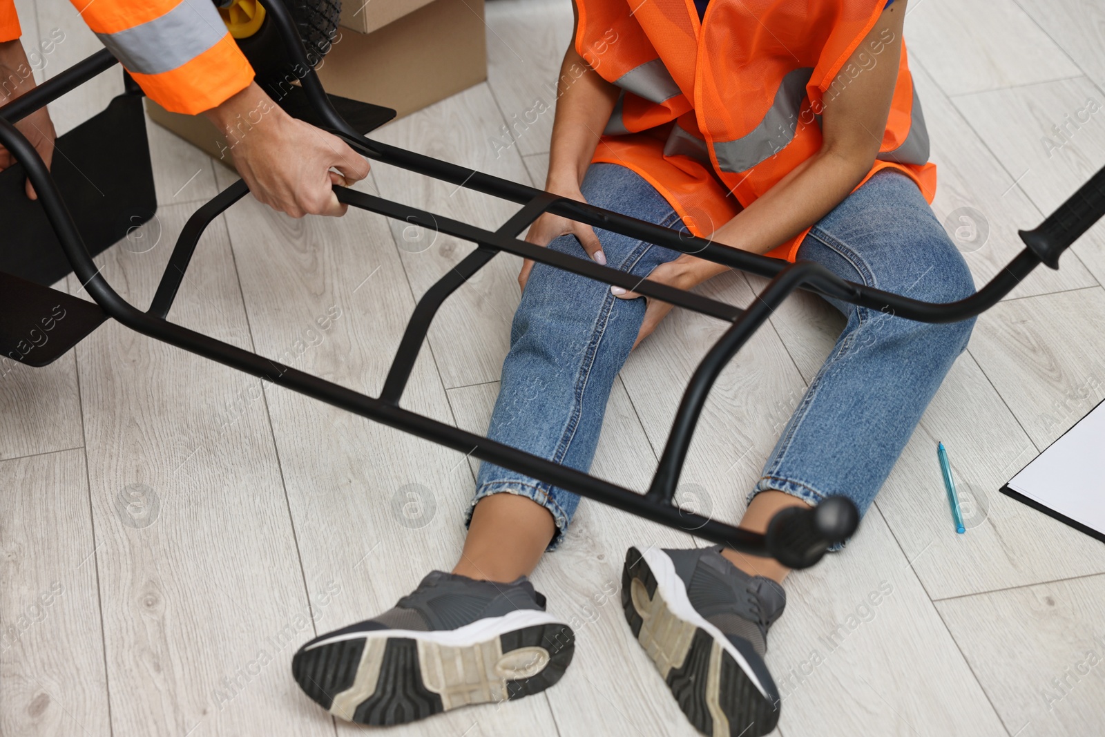 Photo of Man helping his injured colleague after accident at work, closeup