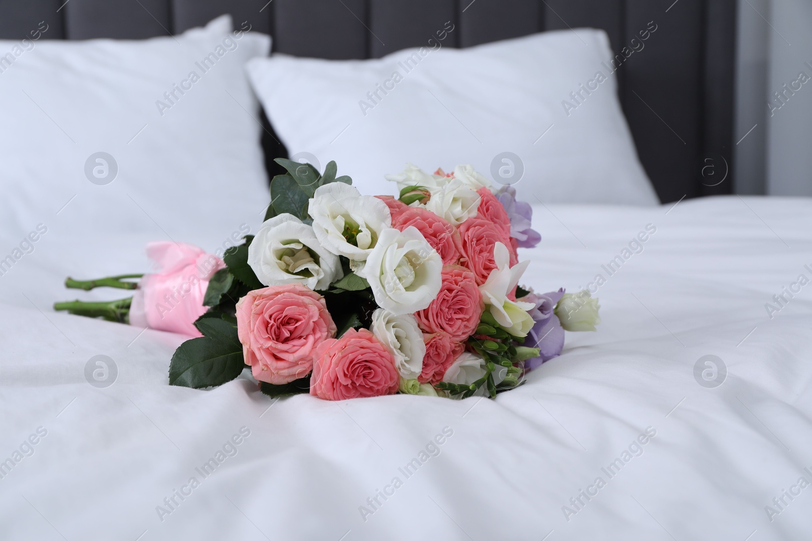 Photo of Wedding bouquet of beautiful flowers on bed, closeup