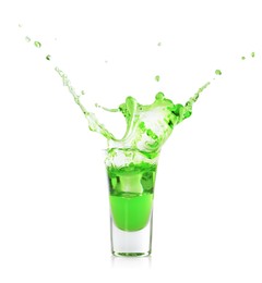 Photo of Delicious absinthe splashing in shot glass on white background