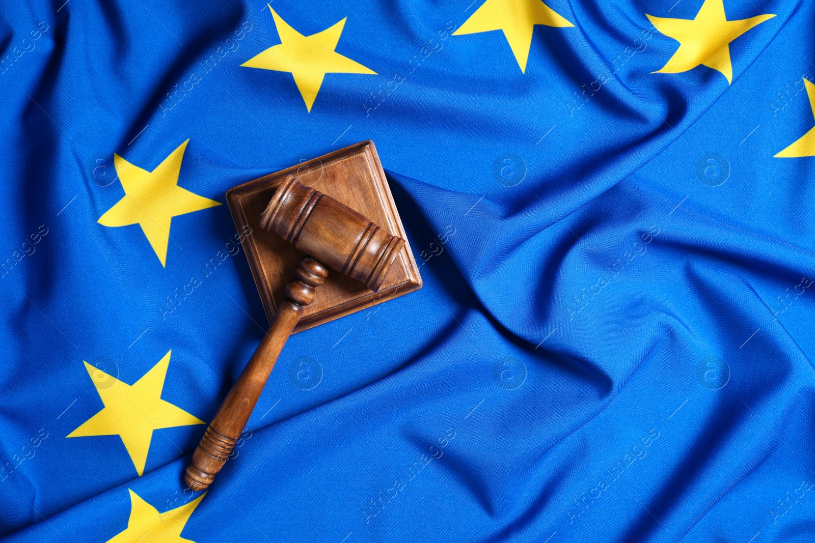 Photo of Judge's gavel on flag of European Union, top view. Space for text