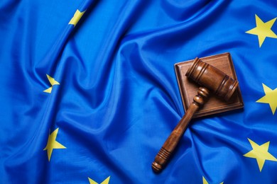 Photo of Judge's gavel on flag of European Union, top view. Space for text