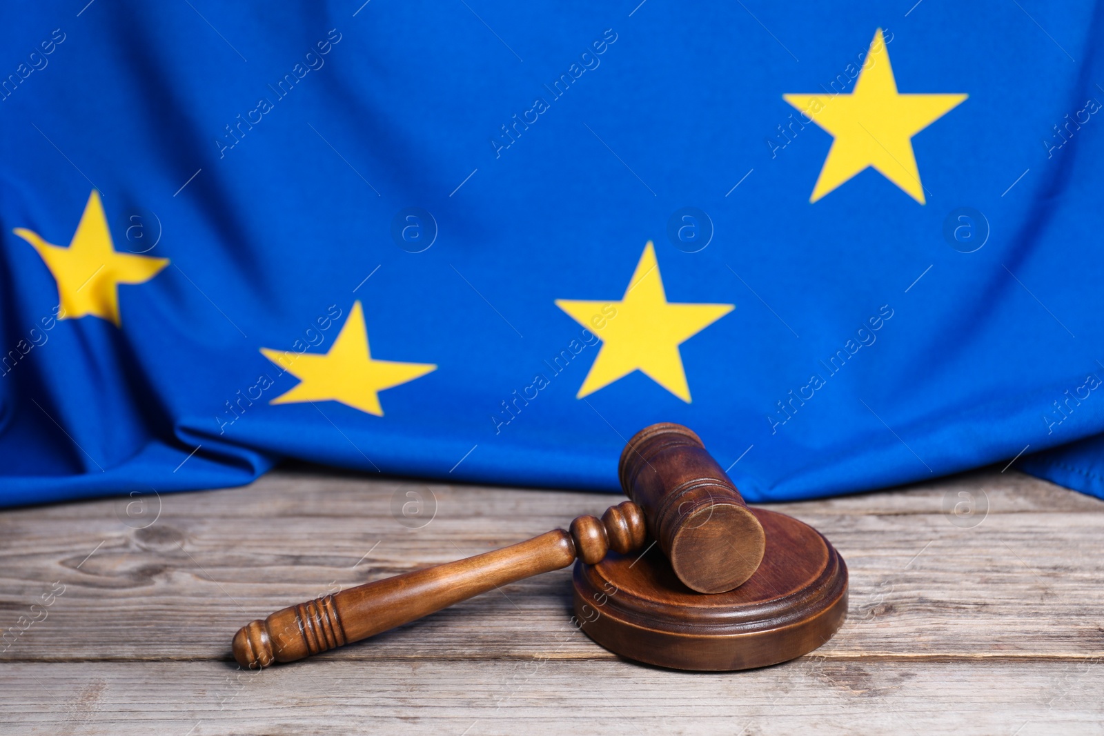 Photo of Judge's gavel and European Union flag on wooden table