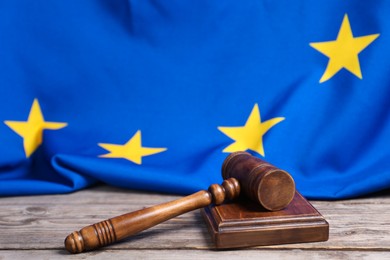 Photo of Judge's gavel and European Union flag on wooden table