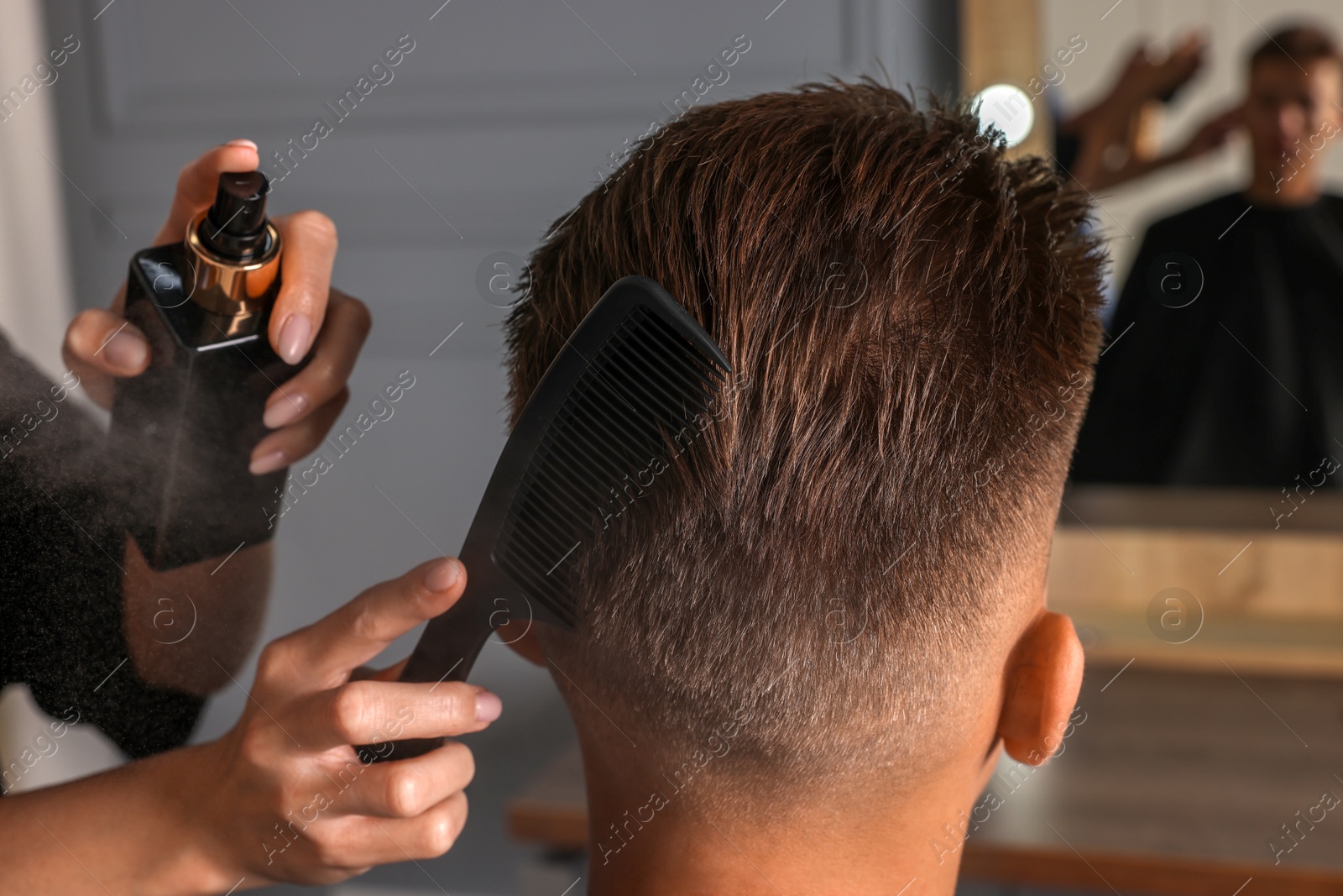 Photo of Hair cutting. Professional hairdresser working with client in barbershop, closeup