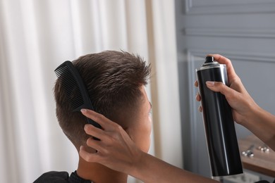 Photo of Hair cutting. Professional hairdresser working with client in barbershop, closeup