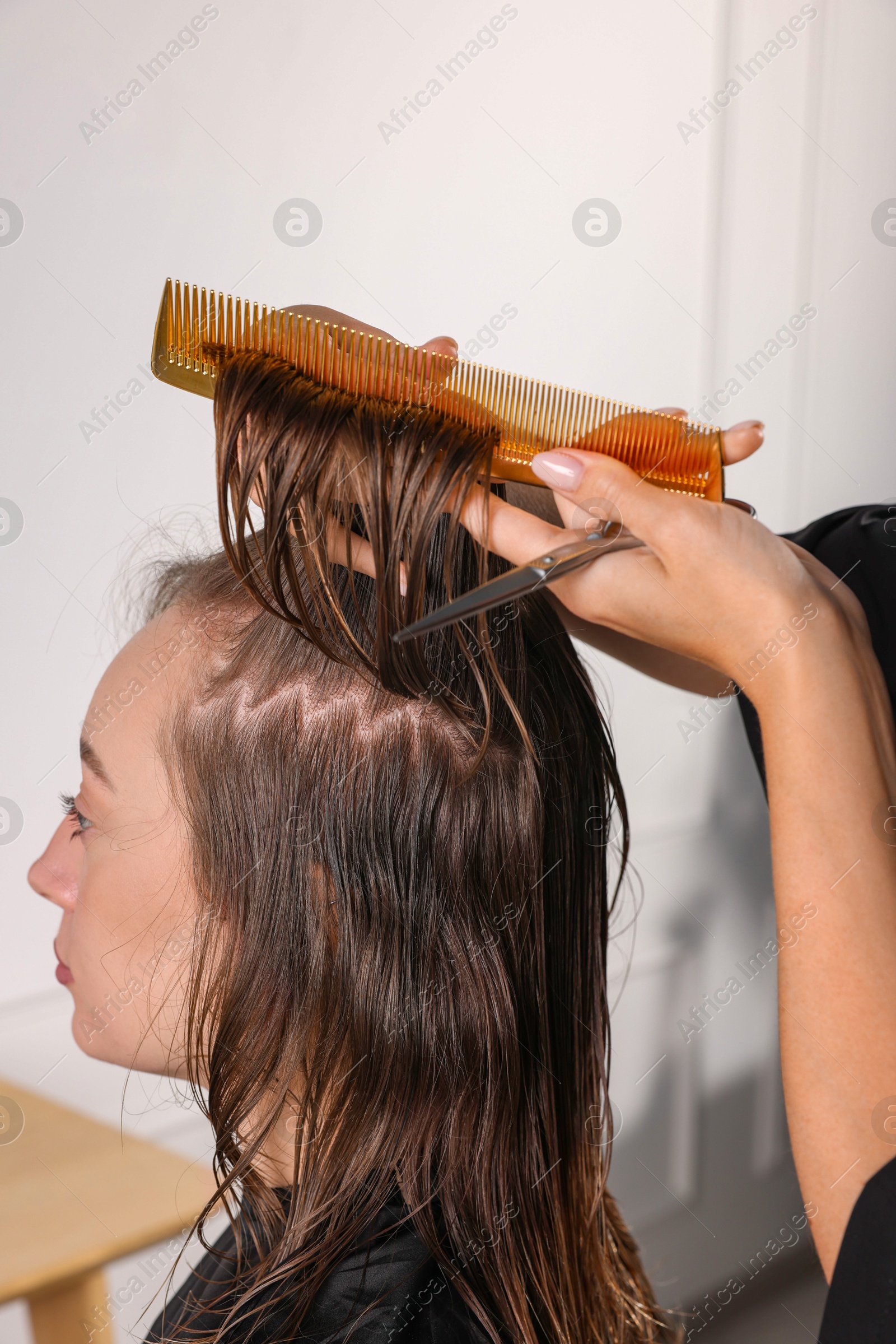 Photo of Hair cutting. Professional hairdresser working with client in salon, closeup