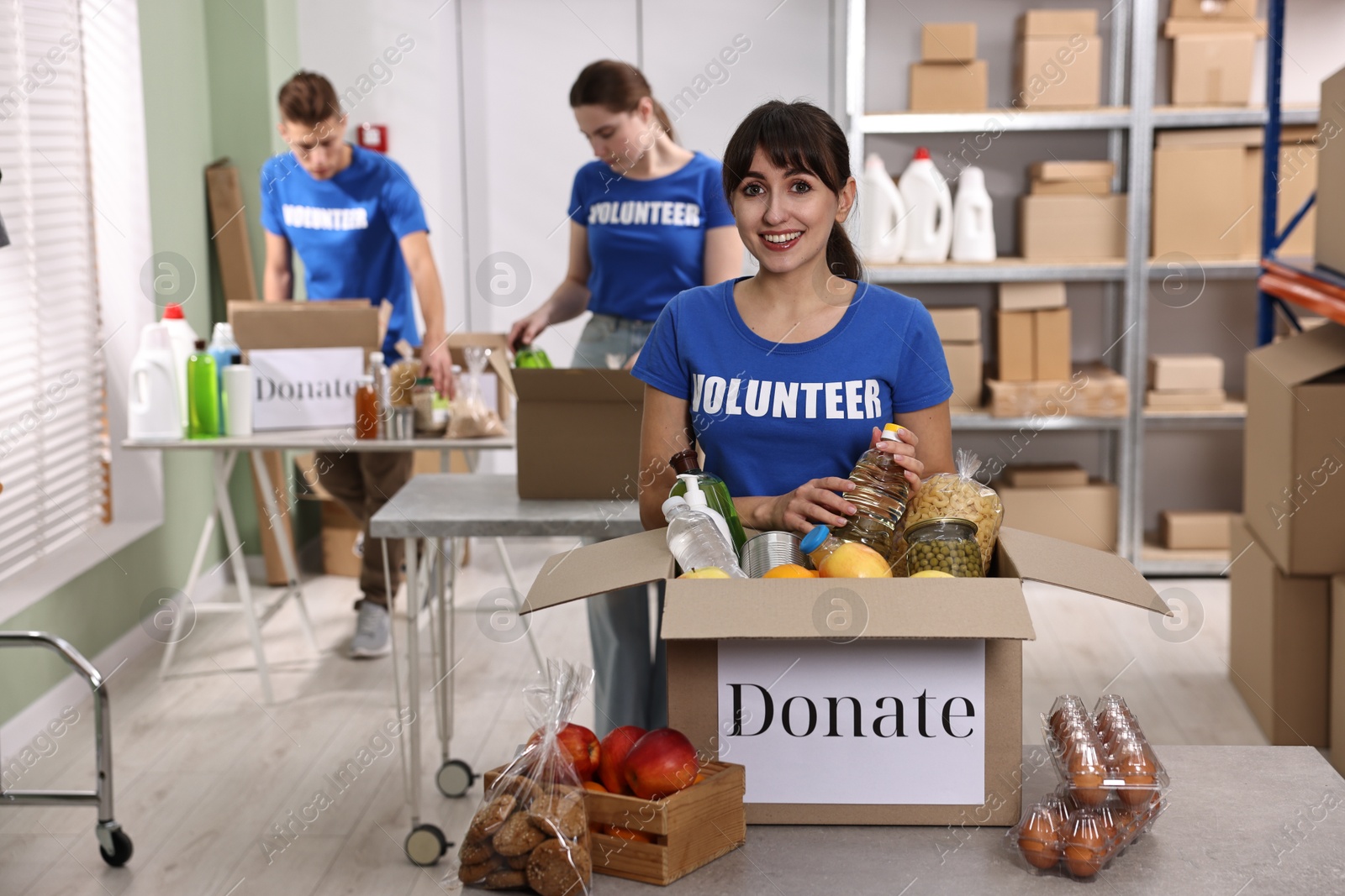 Photo of Volunteers packing food donations at tables indoors