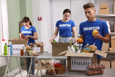 Photo of Volunteers packing food donations at tables indoors