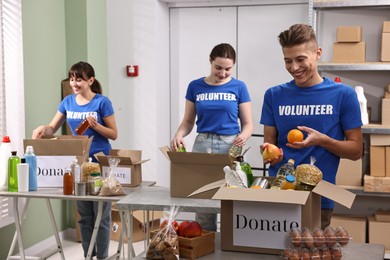 Photo of Volunteers packing food donations at tables indoors