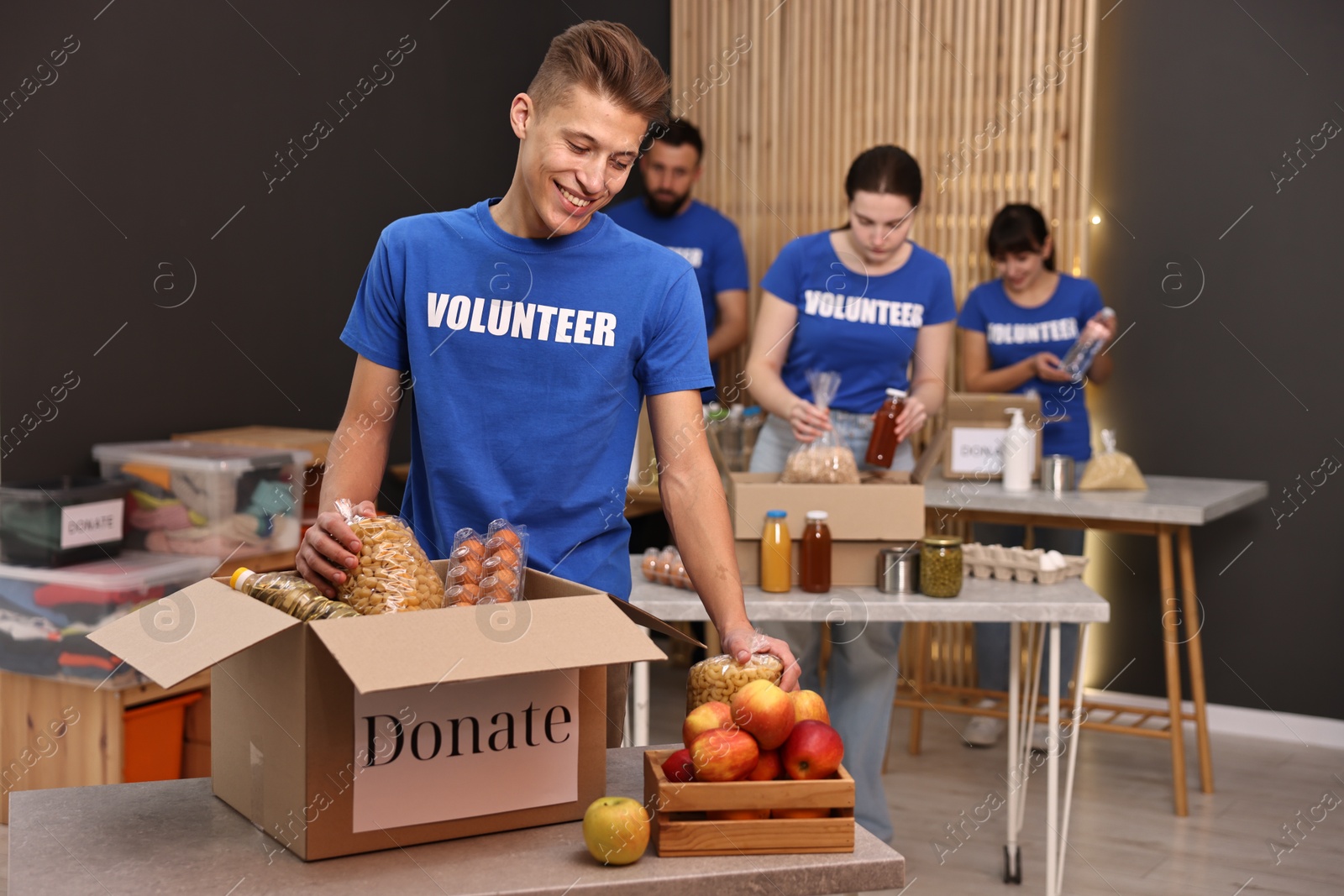 Photo of Volunteers packing food donations at tables indoors