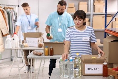 Photo of Volunteers packing donation goods at tables indoors