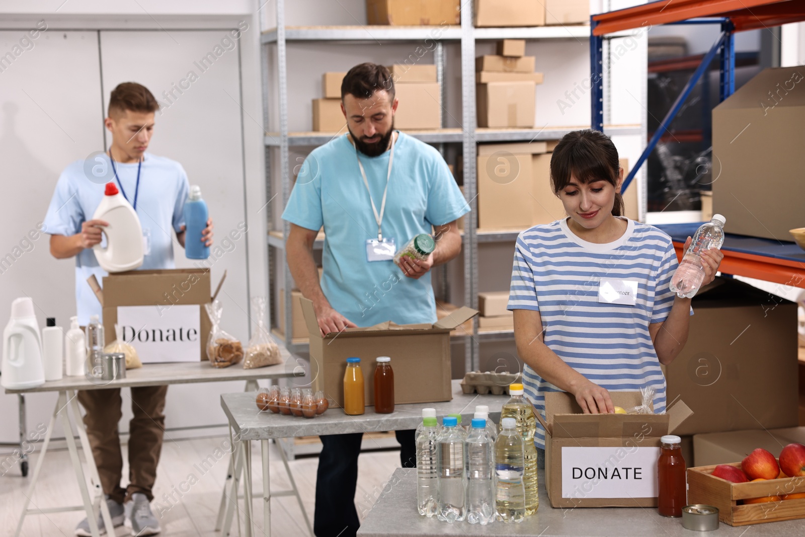 Photo of Volunteers packing donation goods at tables indoors