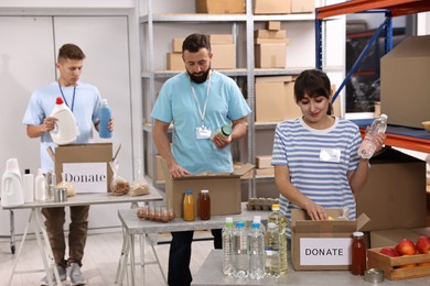 Photo of Volunteers packing donation goods at tables indoors